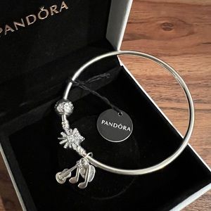 Pandora charm bracelet - “the best is yet to come” engraved.